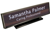 Laser engraved name plates in a variety of color options with attractive, framed display stand.