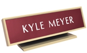 Laser engraved name plates in a variety of color options with attractive, framed display stand.