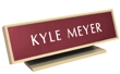 Laser engraved name plates in a variety of color options with attractive, framed display stand.