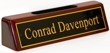 Polished brass name plates with an attractive piano polished wood display base with slot for business cards.